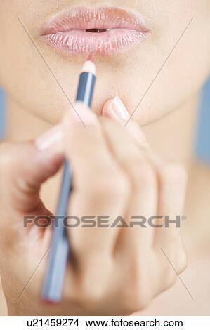 A young woman applying lip liner View Large Photo Image Picture - A young woman applying lip liner. Fotosearch