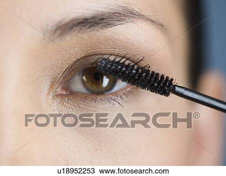 A young woman applying mascara View Large Photo Image Stock Image - A young woman applying mascara. Fotosearch