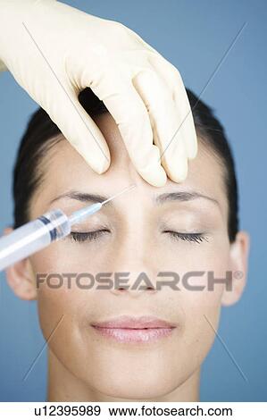 A young woman having botox injections View Large Photo Image Stock Photo - A young woman having botox injections. Fotosearch
