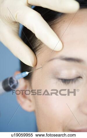 Stock Photography - A young woman having botox injections. Fotosearch