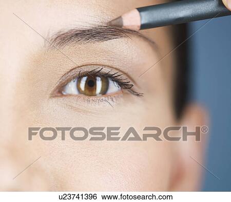 A young woman using an eyebrow pencil View Large Photo Image Stock Photograph - A young woman using an eyebrow pencil. Fotosearch