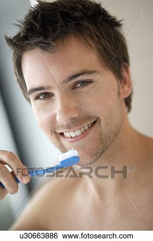 Young man brushing his teeth, close-up View Large Photo Image Stock Photograph - Young man brushing his teeth, close-up. Fotosearch