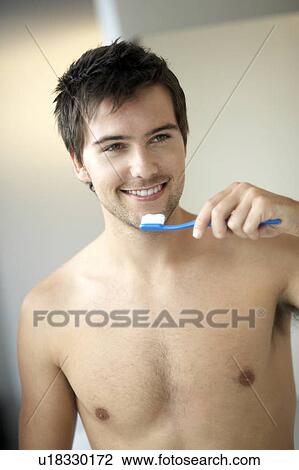 Young man brushing his teeth View Large Photo Image Stock Image - Young man brushing his teeth. Fotosearch