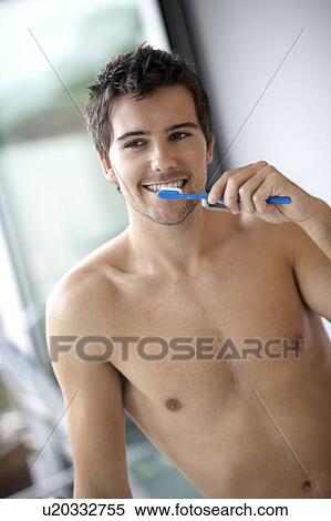 Stock Photography - Young man brushing his teeth. Fotosearch