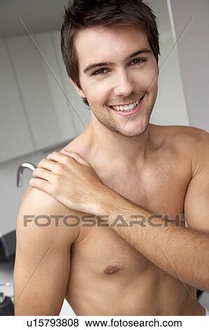 Young man in the bathroom View Large Photo Image Stock Photo - Young man in the bathroom. Fotosearch