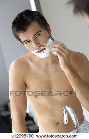 Young man shaving View Large Photo Image Stock Image - Young man shaving. Fotosearch