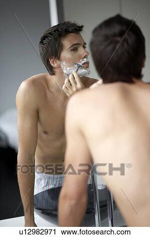 Young man shaving View Large Photo Image Stock Image - Young man shaving. Fotosearch