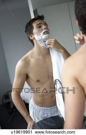 Young man shaving View Large Photo Image Stock Image - Young man shaving. Fotosearch