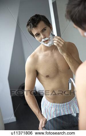 Stock Photograph - Young man shaving. Fotosearch