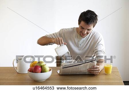 Young man having breakfast View Large Photo Image Stock Image - Young man having breakfast. Fotosearch
