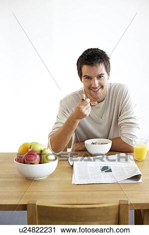 Young man having breakfast View Large Photo Image Stock Image - Young man having breakfast. Fotosearch