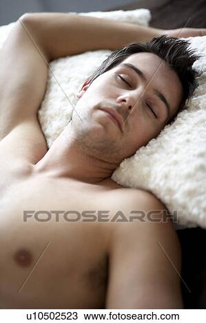 Stock Image - Young man sleeping. Fotosearch