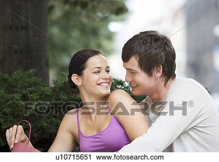 A young couple looking at their purchases View Large Photo Image Stock Image - A young couple looking at their purchases. Fotosearch