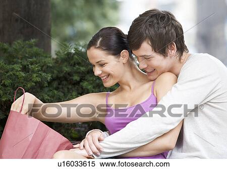 A young couple looking at their purchases View Large Photo Image Stock Photography - A young couple looking at their purchases. Fotosearch