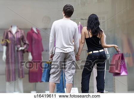 Stock Image - A young couple out shopping. Fotosearch