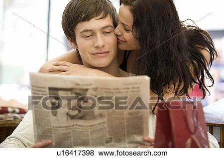 A young couple reading the newspaper View Large Photo Image Stock Photo - A young couple reading the newspaper. Fotosearch