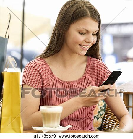 Stock Photo - A young woman having a break from shopping. Fotosearch