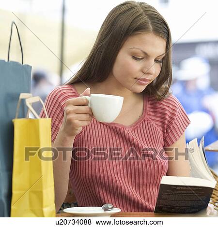 A young woman having a break from shopping View Large Photo Image Stock Photo - A young woman having a break from shopping. Fotosearch