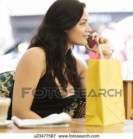 A young woman having a break from shopping View Large Photo Image Stock Photo - A young woman having a break from shopping. Fotosearch