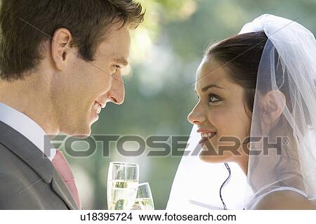 A bride and groom drinking champagne View Large Photo Image Picture - A bride and groom drinking champagne. Fotosearch