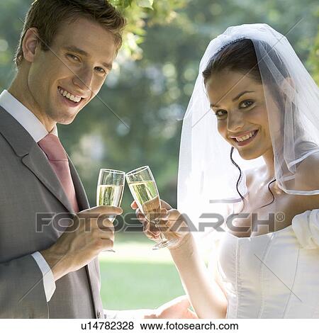 Stock Photo - A bride and groom drinking champagne. Fotosearch