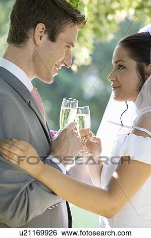 A bride and groom drinking champagne View Large Photo Image Stock Photograph - A bride and groom drinking champagne. Fotosearch