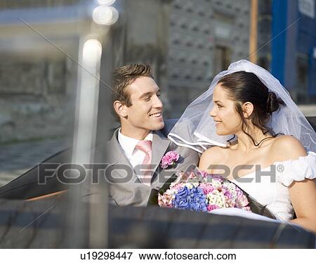 A bride and groom sitting in the wedding car View Large Photo Image Stock Photo - A bride and groom sitting in the wedding car. Fotosearch