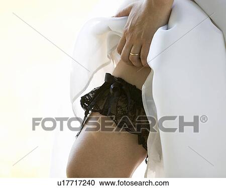 Stock Image - A bride showing her garter. Fotosearch