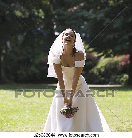 Picture - A bride throwing her bouquet. Fotosearch