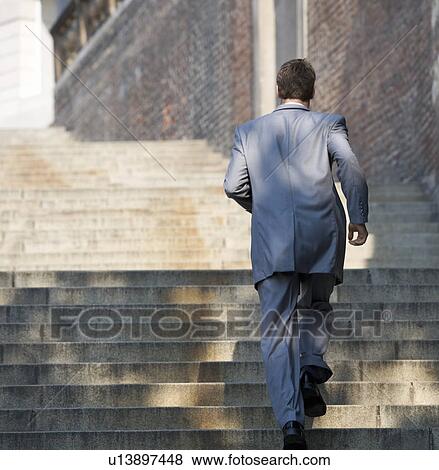 Stock Photo - A groom running to the church. Fotosearch
