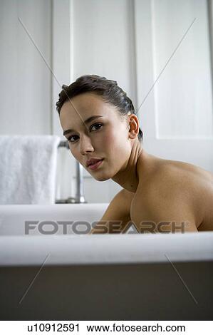 A young woman laying in a bath View Large Photo Image Stock Image - A young woman laying in a bath. Fotosearch