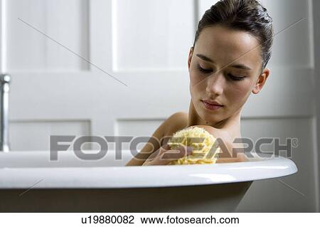 A young woman laying in a bath View Large Photo Image Stock Image - A young woman laying in a bath. Fotosearch