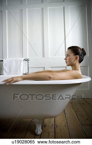 A young woman laying in a bath View Large Photo Image Stock Photography - A young woman laying in a bath. Fotosearch
