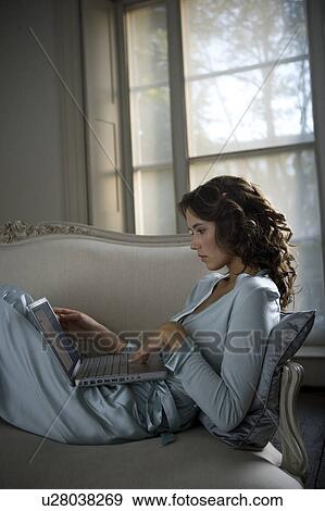 Stock Photo - A young woman using a laptop. Fotosearch