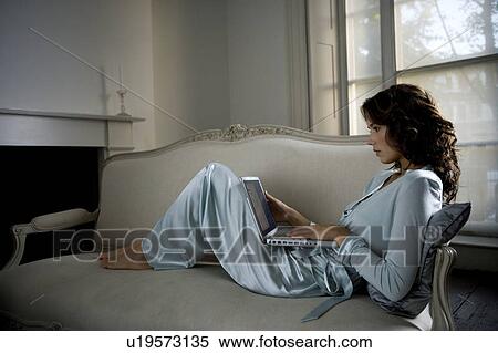 Stock Photography - A young woman using a laptop. Fotosearch