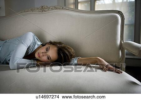 Picture - A young woman wearing silk pyjamas. Fotosearch