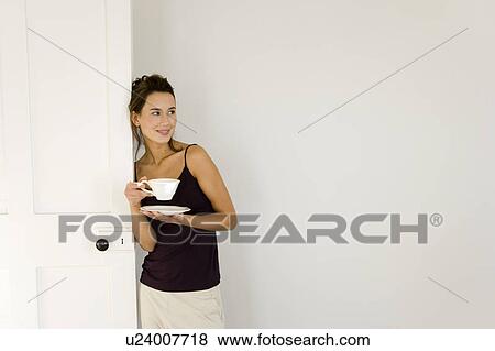 A young woman drinking from a cup View Large Photo Image Stock Photo - A young woman drinking from a cup. Fotosearch