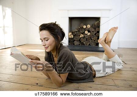 Stock Photograph - A young woman reading a book. Fotosearch