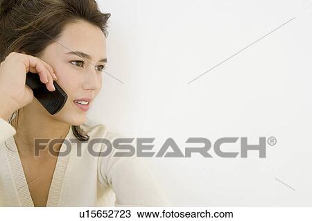 A young woman using a mobile phone View Large Photo Image Stock Image - A young woman using a mobile phone. Fotosearch