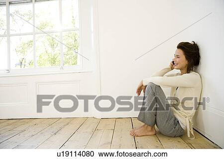 A young woman using a mobile phone View Large Photo Image Stock Image - A young woman using a mobile phone. Fotosearch