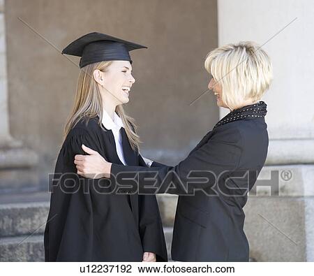 A graduate hugging her mother View Large Photo Image Stock Image - A graduate hugging her mother. Fotosearch