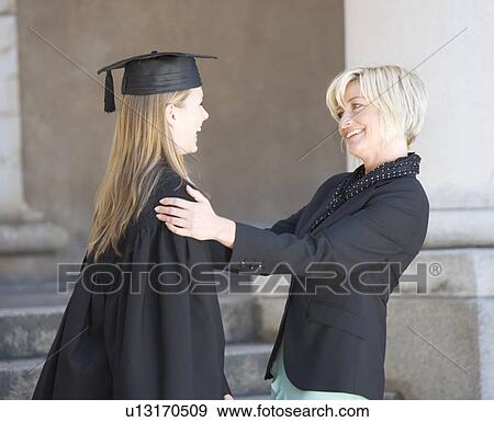 A graduate hugging her mother View Large Photo Image Stock Photo - A graduate hugging her mother. Fotosearch