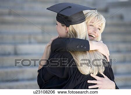 Stock Photograph - A graduate hugging her mother. Fotosearch