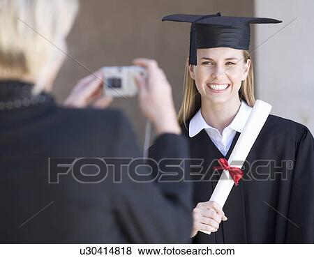 A graduate posing for a family photograph View Large Photo Image Stock Photo - A graduate posing for a family photograph. Fotosearch