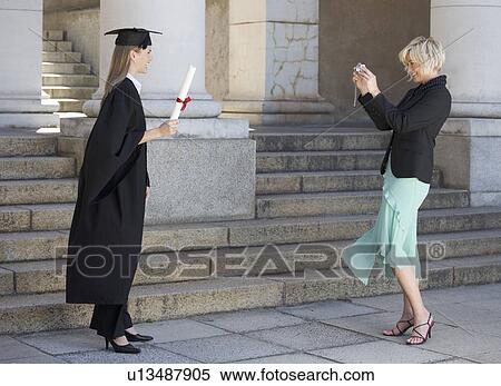 A graduate posing for a family photograph View Large Photo Image Stock Photography - A graduate posing for a family photograph. Fotosearch