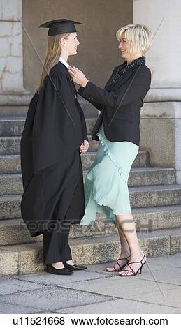 A mother checking her graduate daughter's gown View Large Photo Image Stock Photo - A mother checking her graduate daughter's gown. Fotosearch