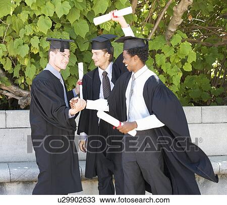 Stock Image - Three graduates celebrating. Fotosearch