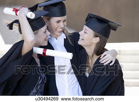 Three graduates celebrating View Large Photo Image Stock Photo - Three graduates celebrating. Fotosearch