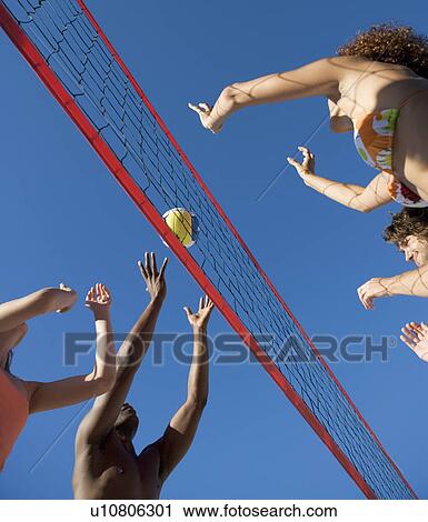 A game of beach volleyball View Large Photo Image Stock Image - A game of beach volleyball. Fotosearch