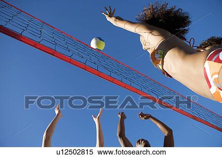 A game of beach volleyball View Large Photo Image Stock Photography - A game of beach volleyball. Fotosearch